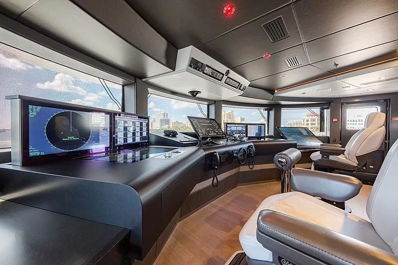 inside of a car with a computer and monitors aboard SPECTRE Yacht for Sale