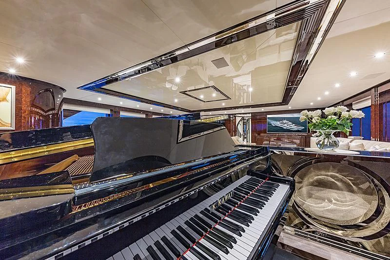 a piano in a room aboard SPECTRE Yacht for Sale