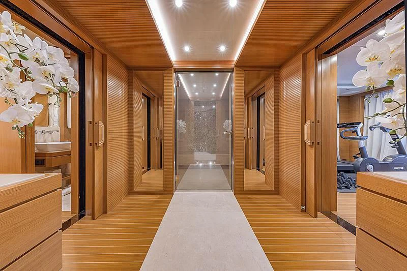 a long hallway with a glass door aboard SPECTRE Yacht for Sale