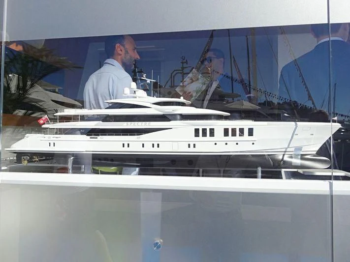 a man standing at a white boat aboard SPECTRE Yacht for Sale