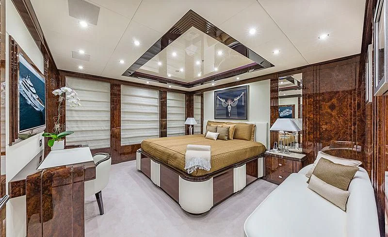 a large room with a bed and a large mirror aboard SPECTRE Yacht for Sale