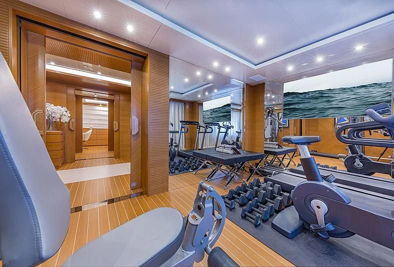 a room with a pool table and chairs aboard SPECTRE Yacht for Sale