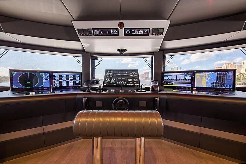 a room with a desk and a computer on the desk aboard SPECTRE Yacht for Sale