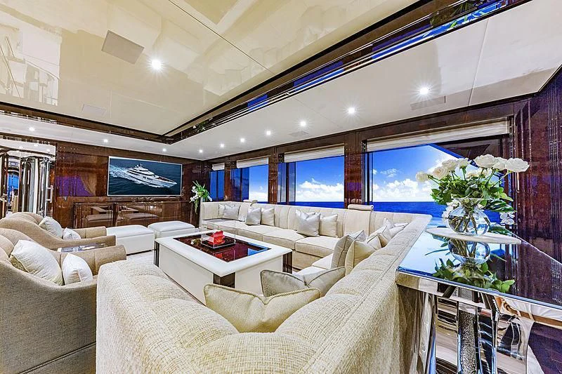 a living room with a large screen aboard SPECTRE Yacht for Sale