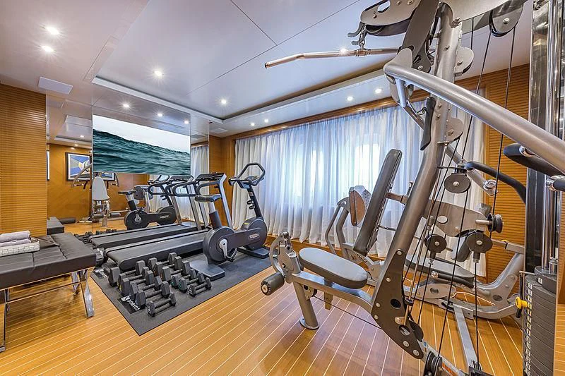 a large gym with equipment aboard SPECTRE Yacht for Sale