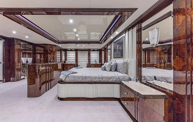 a bedroom with a bed and a desk aboard SPECTRE Yacht for Sale