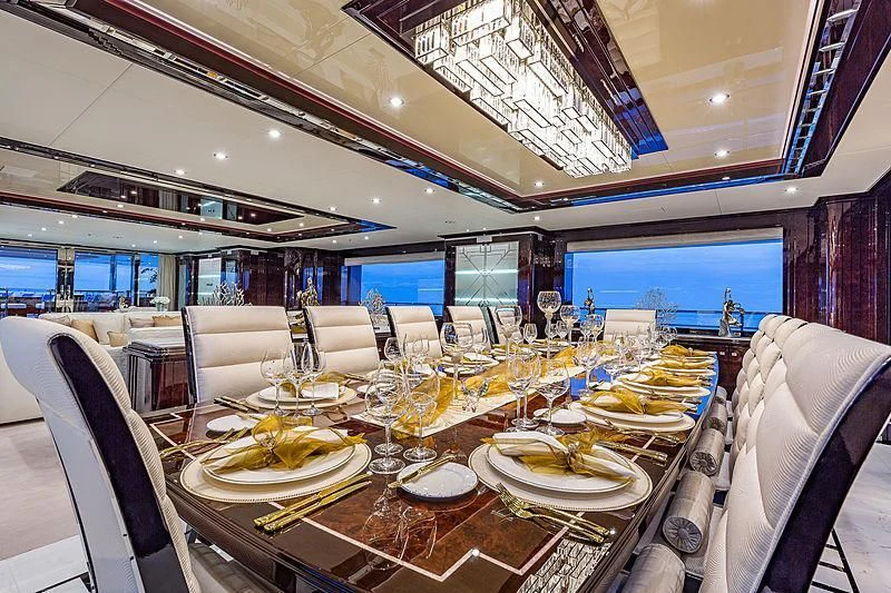 a dining room with a table set for a dinner aboard SPECTRE Yacht for Sale