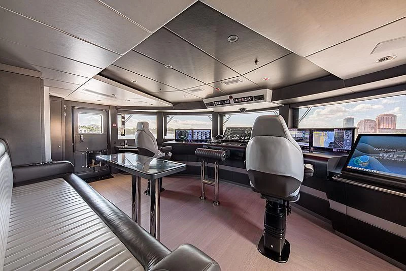 a room with a table and chairs aboard SPECTRE Yacht for Sale