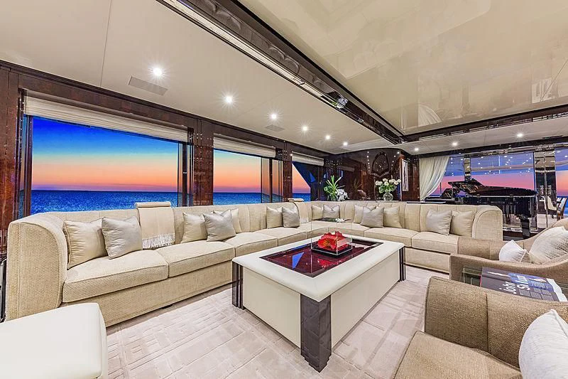a living room with a large screen aboard SPECTRE Yacht for Sale