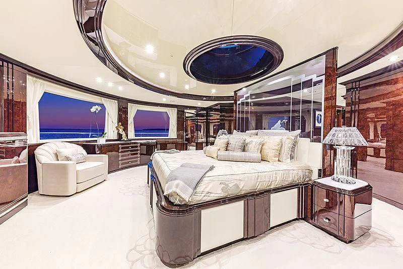 a bedroom with a large mirror aboard SPECTRE Yacht for Sale