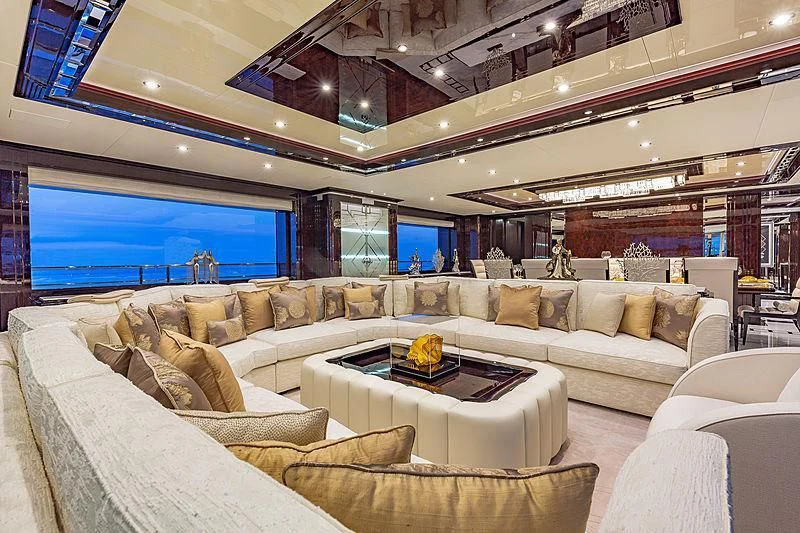 a living room with a large screen aboard SPECTRE Yacht for Sale
