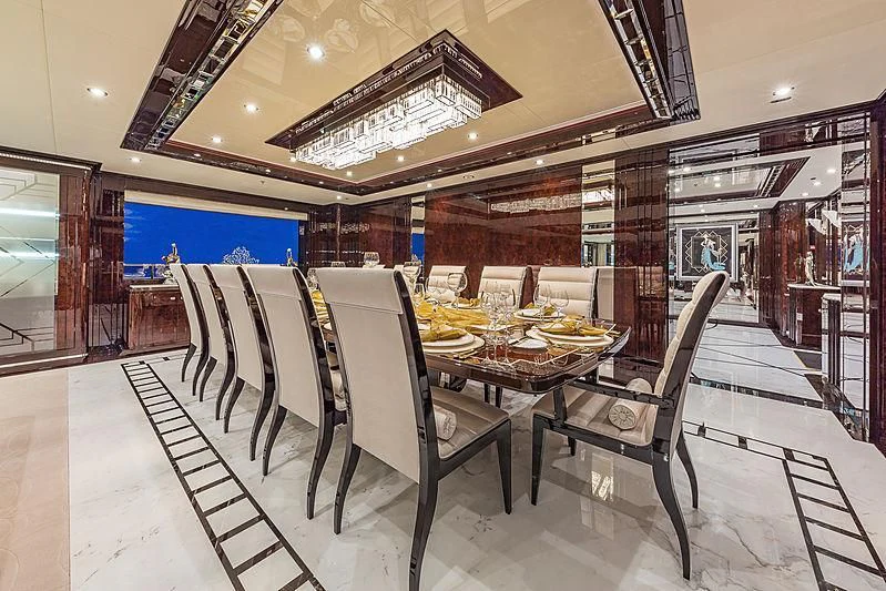 a dining room with a table and chairs aboard SPECTRE Yacht for Sale
