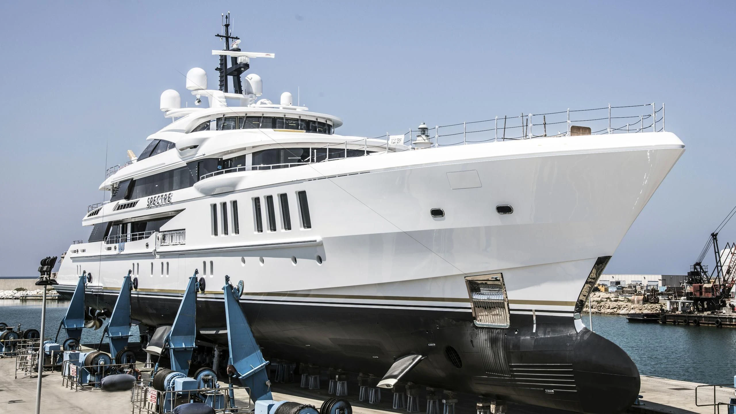 a large white yacht docked aboard SPECTRE Yacht for Sale