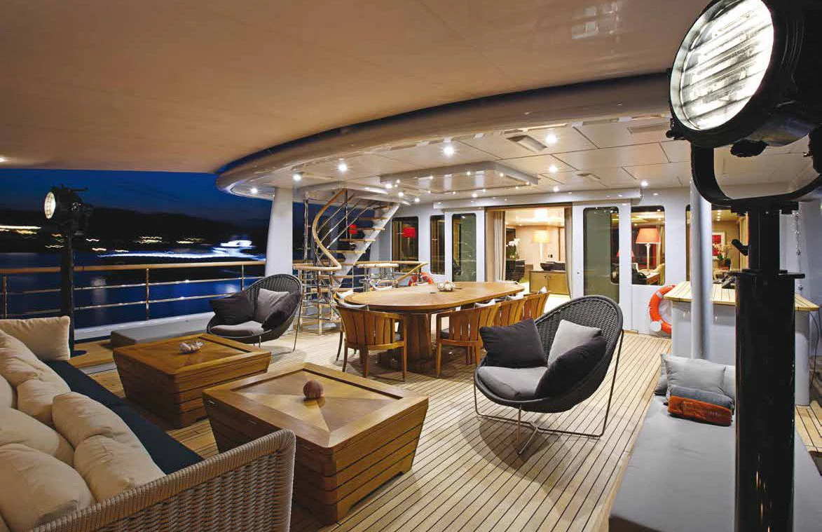 a room with a table chairs and a large window aboard GENE MACHINE Yacht for Sale