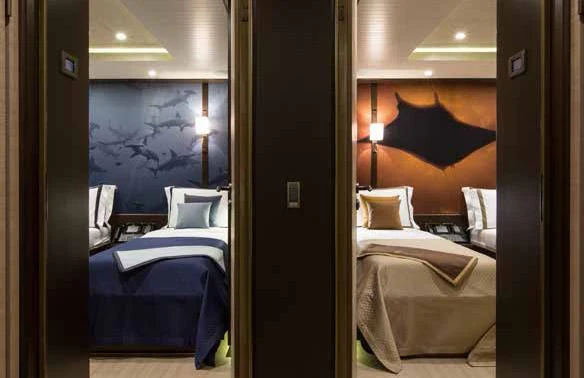 a room with two beds aboard GENE MACHINE Yacht for Sale