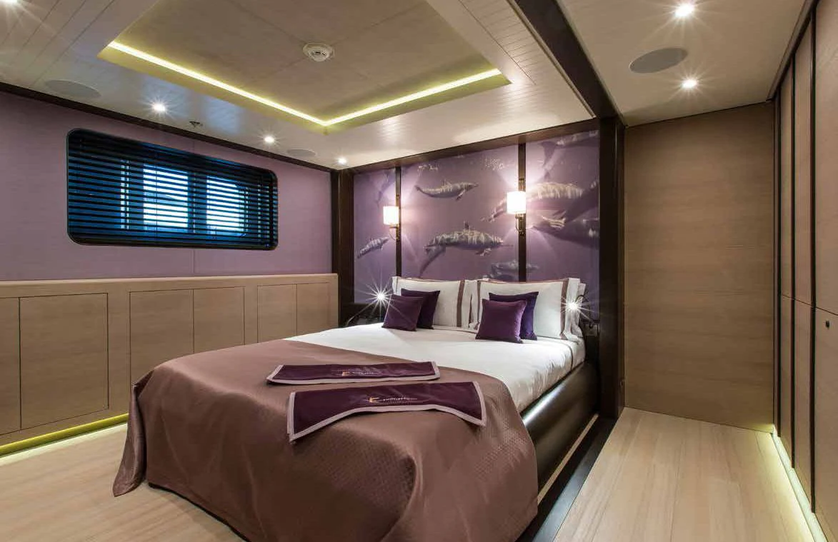 a room with a bed and a window aboard GENE MACHINE Yacht for Sale