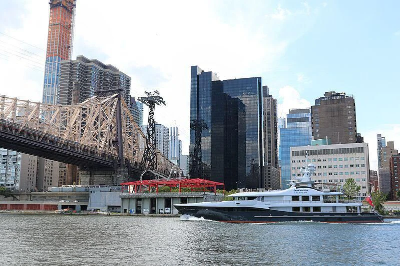 a boat in the water by a bridge and a city aboard GENE MACHINE Yacht for Sale