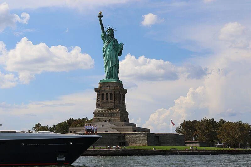 a large statue of a person holding a torch aboard GENE MACHINE Yacht for Sale