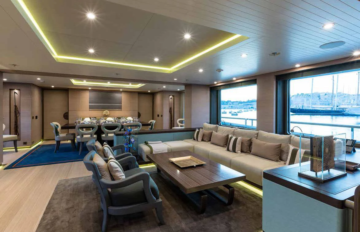 a living room with a couch and a table aboard GENE MACHINE Yacht for Sale