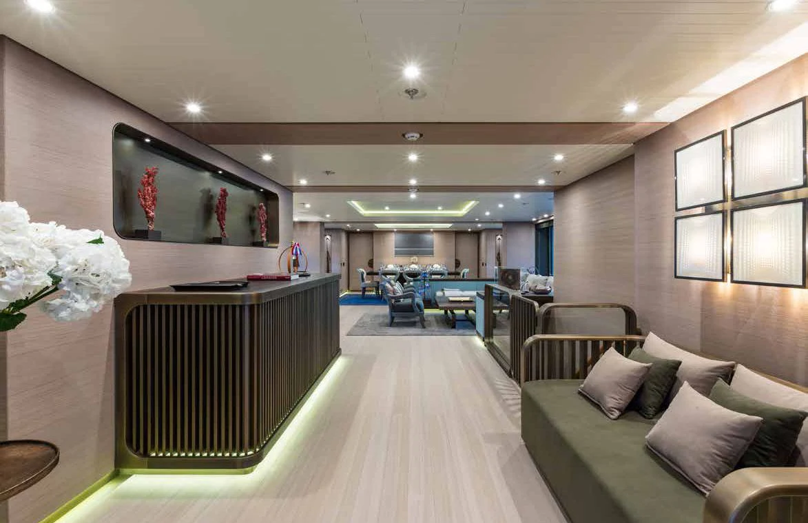 a room with a couch and a television on the wall aboard GENE MACHINE Yacht for Sale