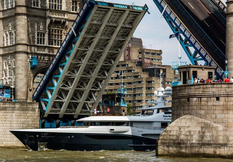 a boat under a bridge aboard GENE MACHINE Yacht for Sale