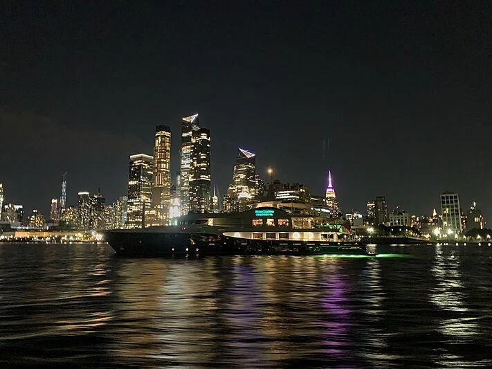 a city with lights on aboard GENE MACHINE Yacht for Sale