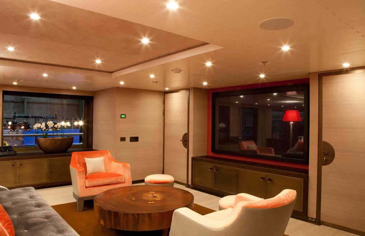 a living room with a table and chairs aboard GENE MACHINE Yacht for Sale