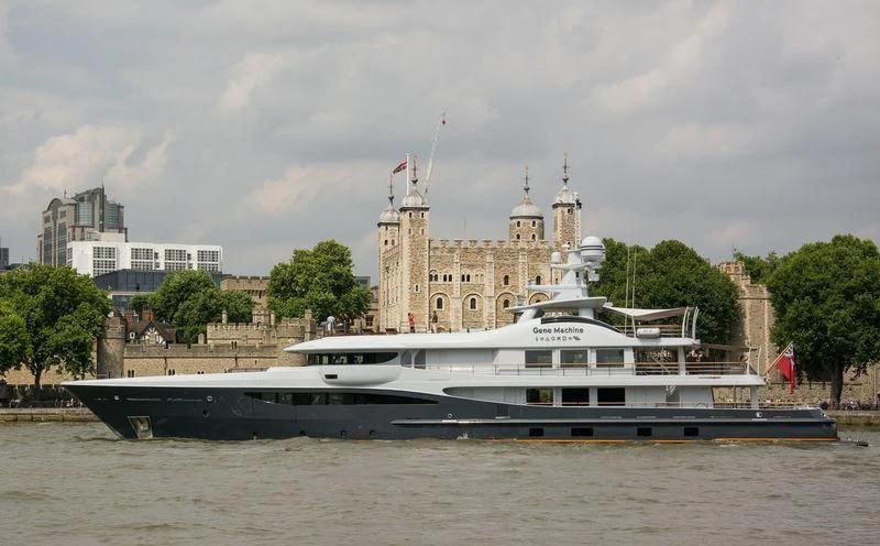 a large boat in front of a large building aboard GENE MACHINE Yacht for Sale