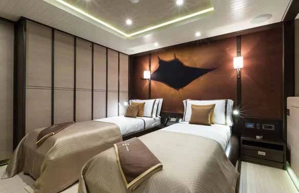 a room with a bed and a desk aboard GENE MACHINE Yacht for Sale