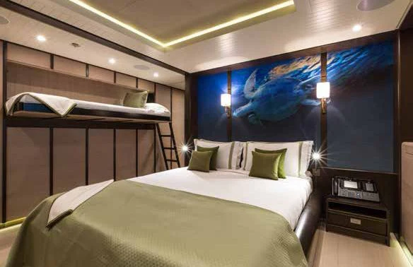 a room with a bed and a desk aboard GENE MACHINE Yacht for Sale