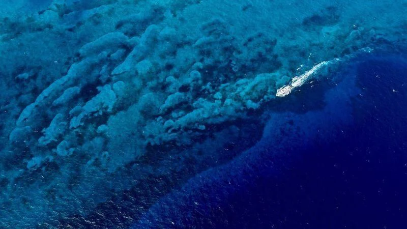 a wave crashing on the shore aboard GENE MACHINE Yacht for Sale
