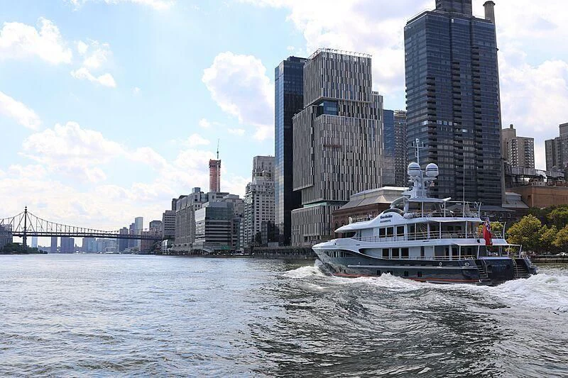 a boat sailing on a river aboard GENE MACHINE Yacht for Sale