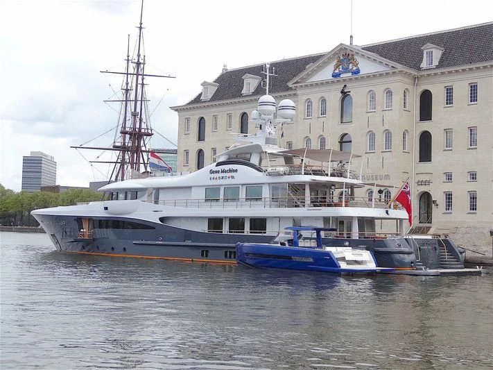 a boat docked in front of a building aboard GENE MACHINE Yacht for Sale