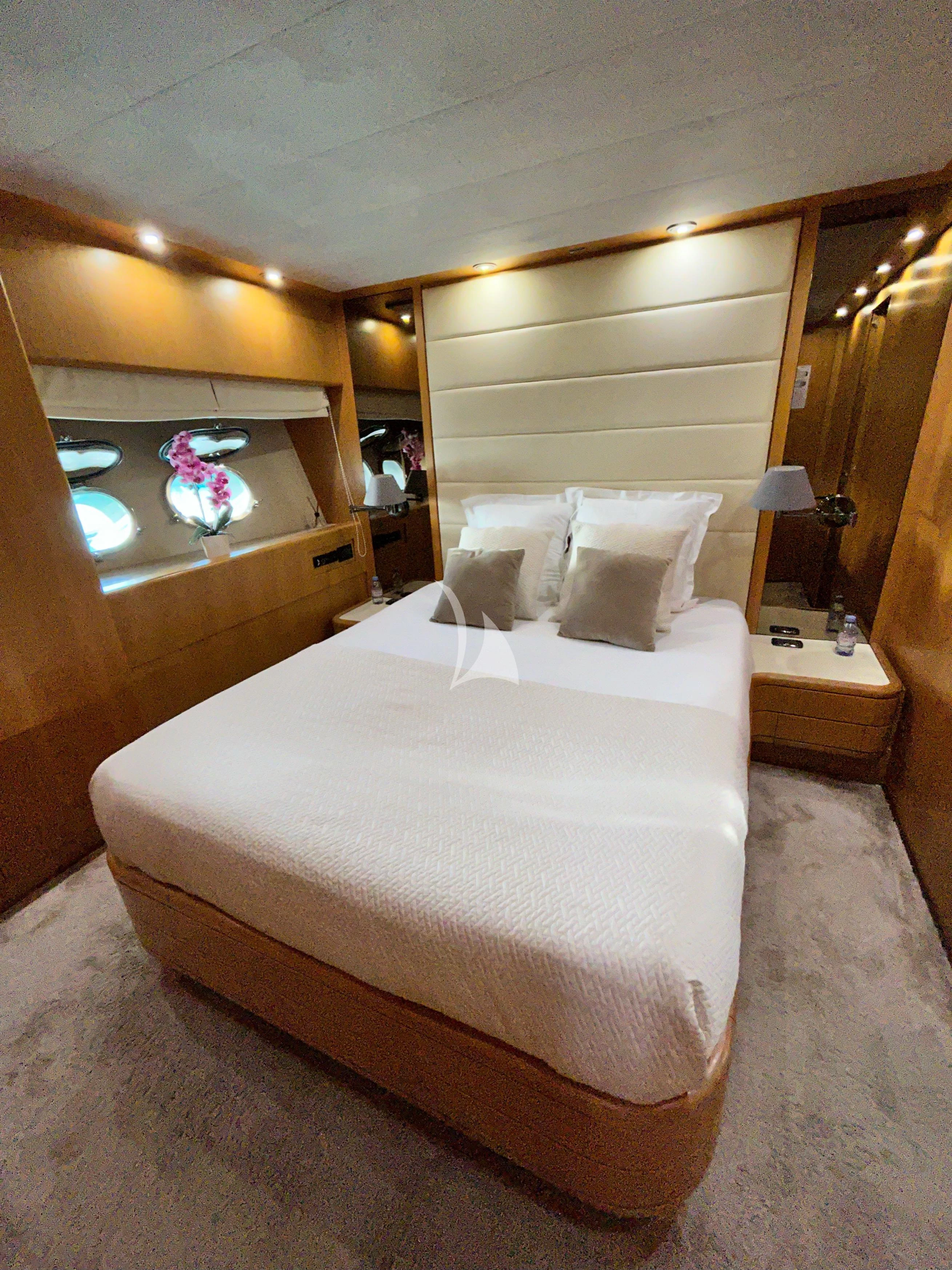 a bed with a white sheet aboard LOLEA Yacht for Charter