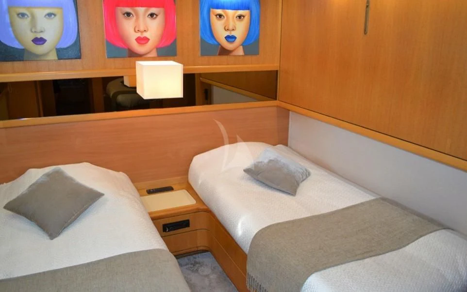 a bed with a headboard and a pillow on it aboard LOLEA Yacht for Charter
