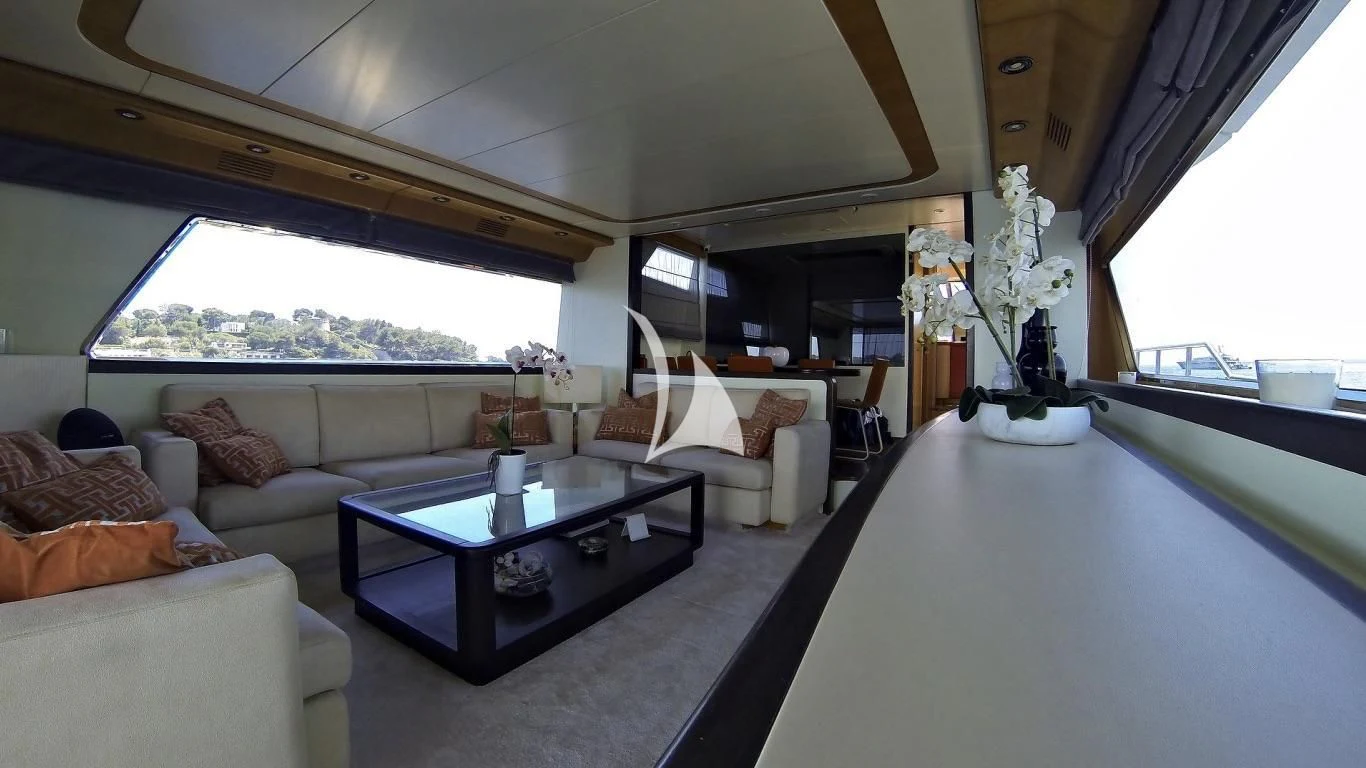 a living room with a table and couches aboard LOLEA Yacht for Charter