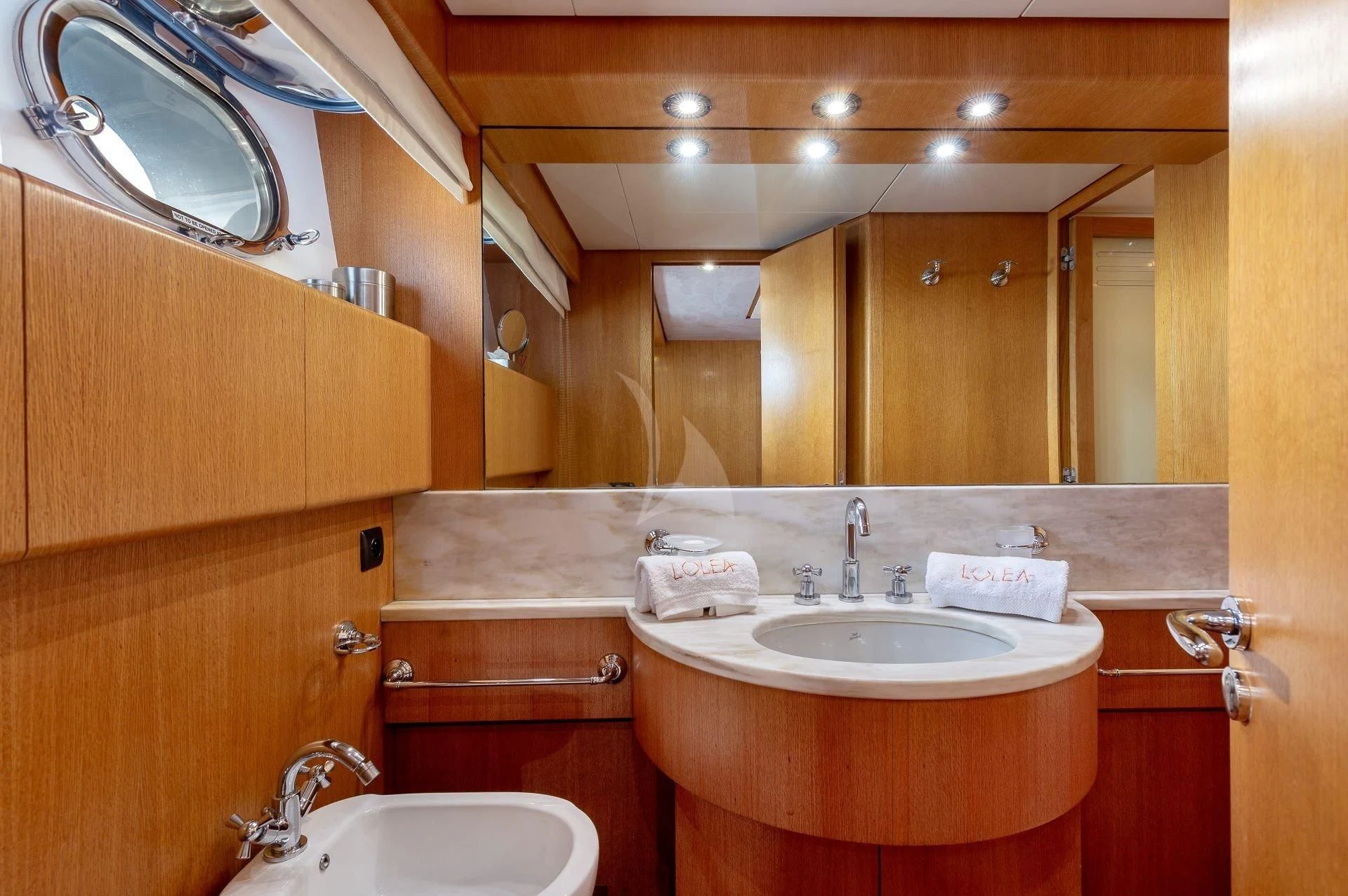 a bathroom with a sink and a mirror aboard LOLEA Yacht for Charter