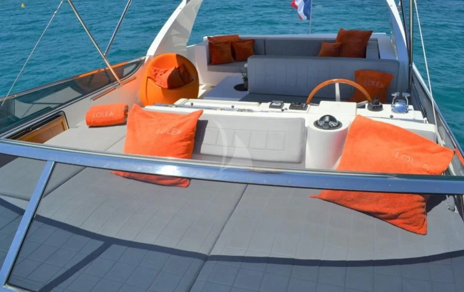 a white and orange boat on a deck aboard LOLEA Yacht for Charter