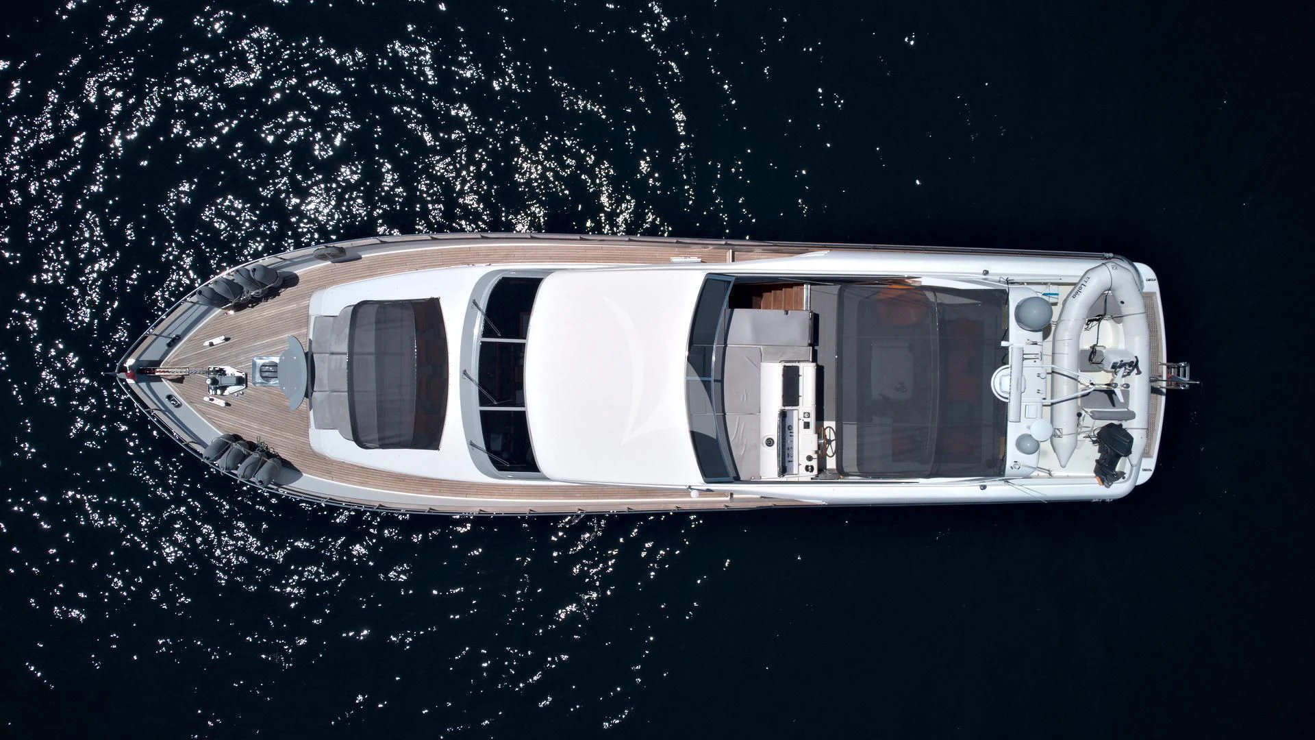 a white car with a black background aboard LOLEA Yacht for Charter