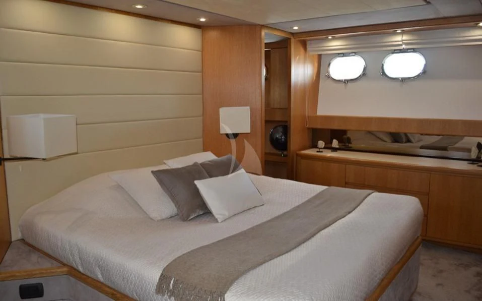 a bed with white sheets aboard LOLEA Yacht for Charter