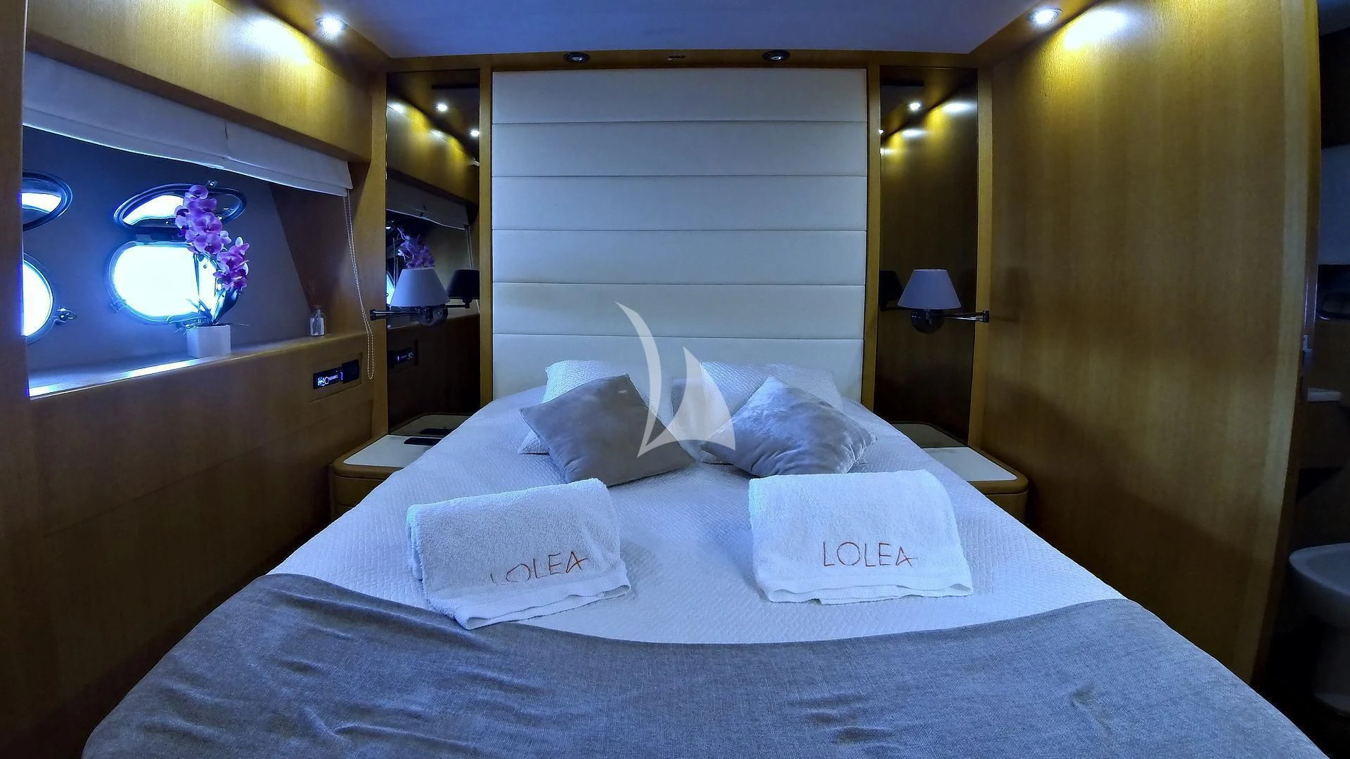 a bed with white sheets aboard LOLEA Yacht for Charter