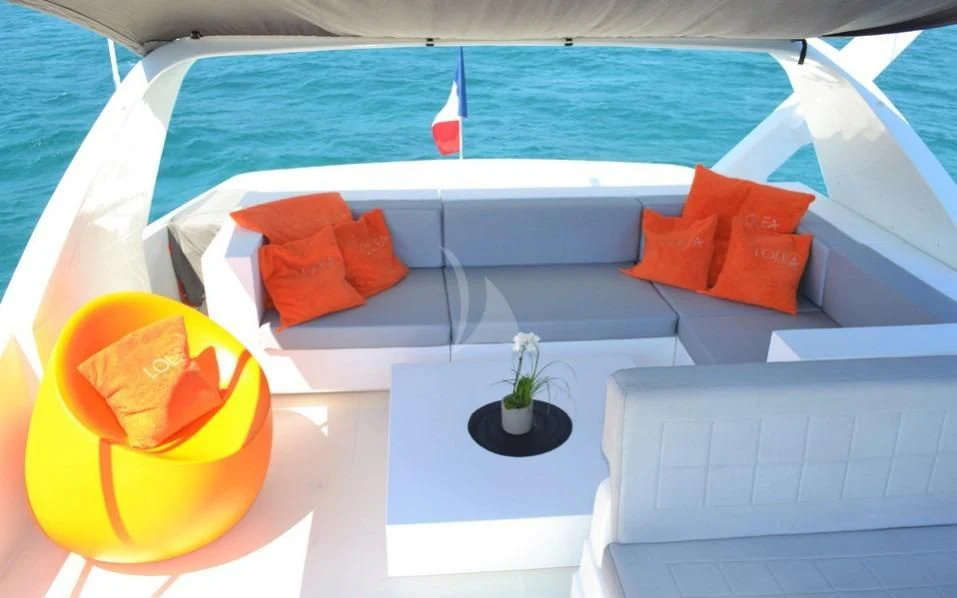 a pool with a table and chairs aboard LOLEA Yacht for Charter