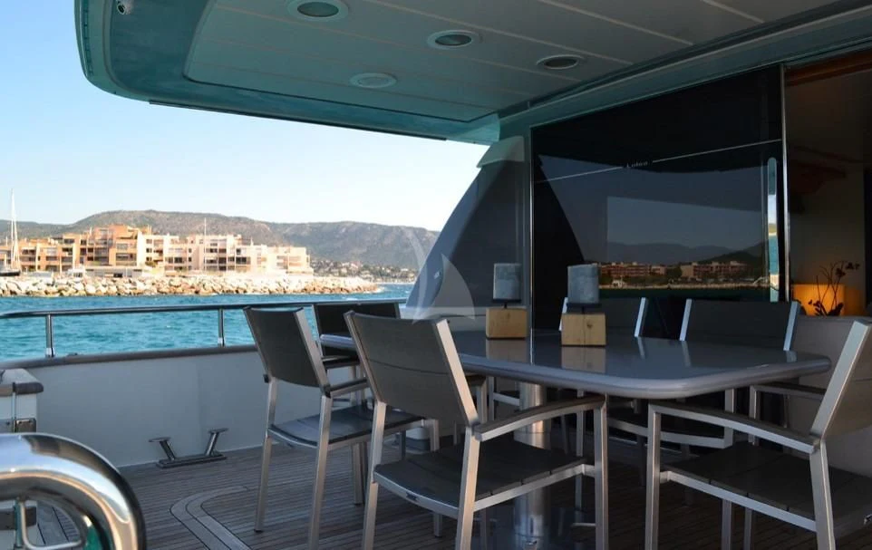 a table and chairs on a boat aboard LOLEA Yacht for Charter