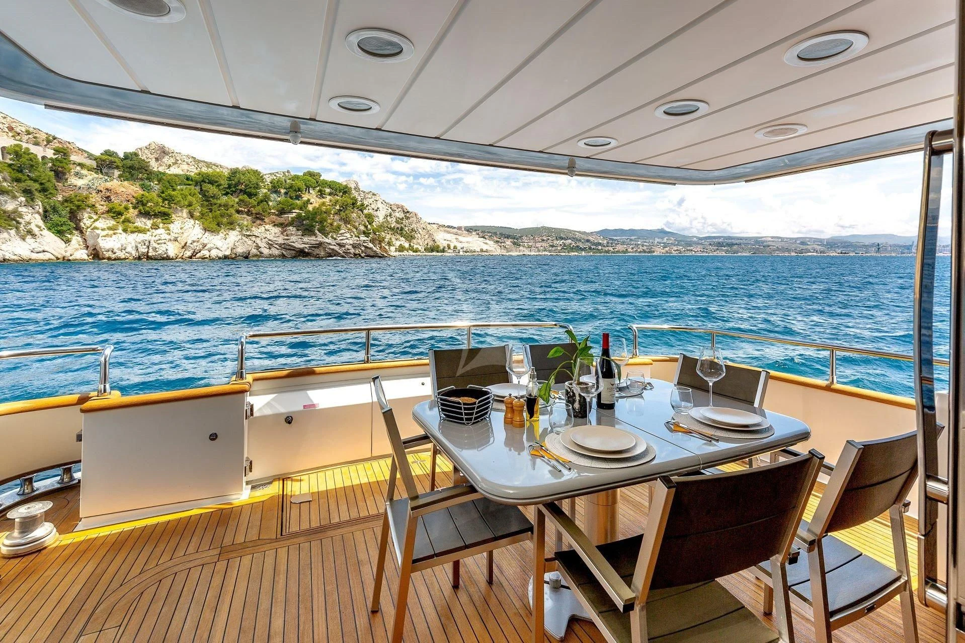 a table set for a meal on a boat aboard LOLEA Yacht for Charter