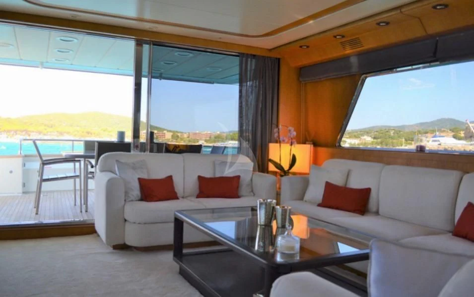 a living room with a large window aboard LOLEA Yacht for Charter