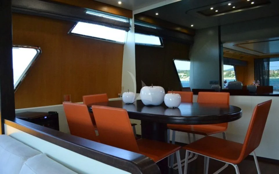a room with tables and chairs aboard LOLEA Yacht for Charter