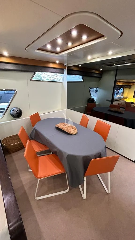 a restaurant with a table and chairs aboard LOLEA Yacht for Charter