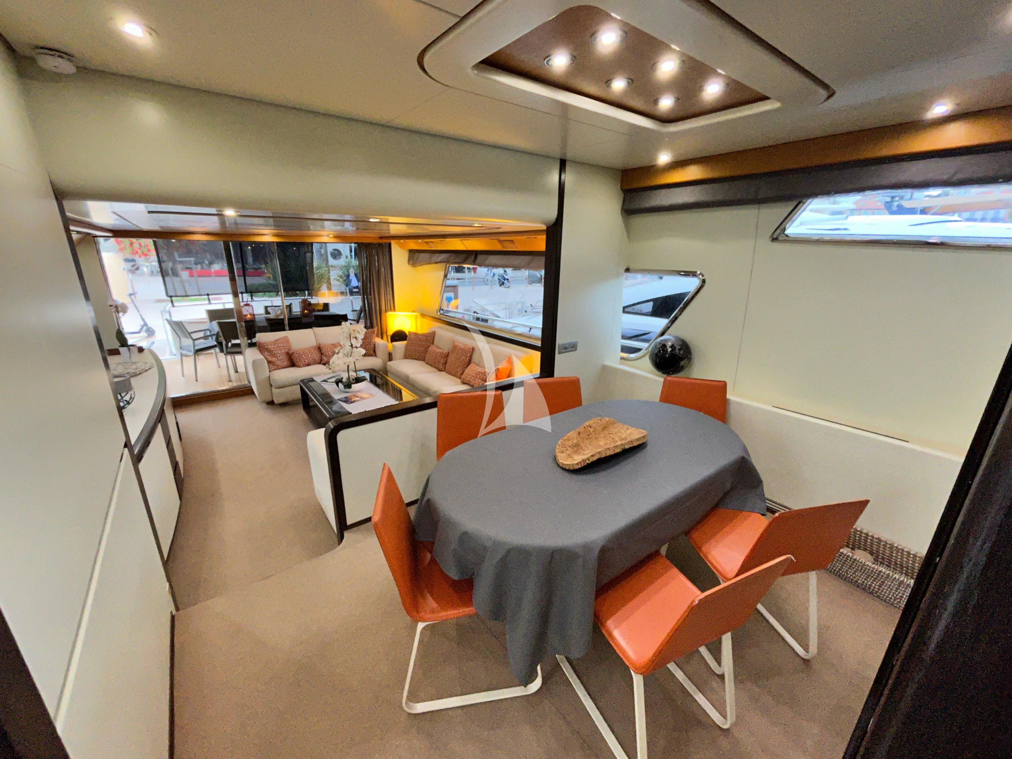 a room with a table chairs and a couch aboard LOLEA Yacht for Charter