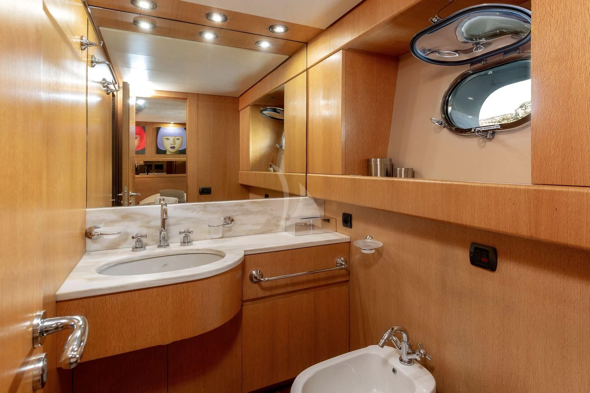 a bathroom with two sinks and mirrors aboard LOLEA Yacht for Charter