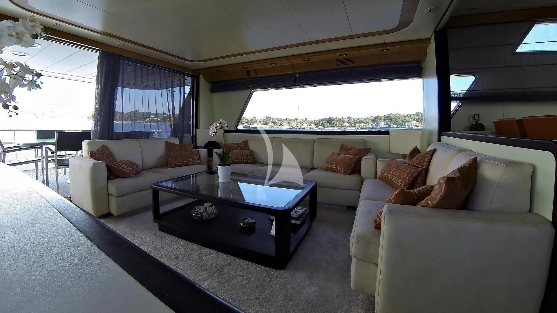 a living room with a couch and a coffee table aboard LOLEA Yacht for Charter